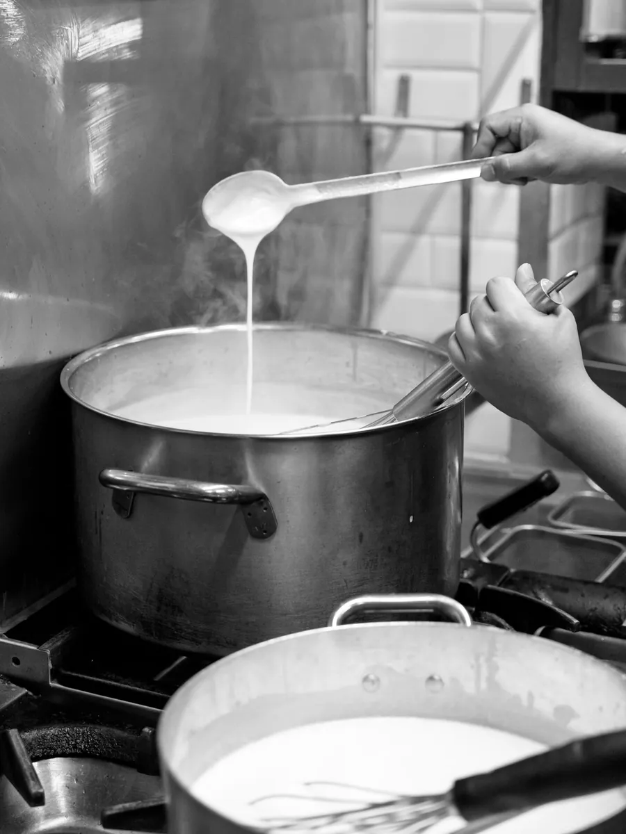 Homemade béchamel being prepared at Le Moline, Bologna
