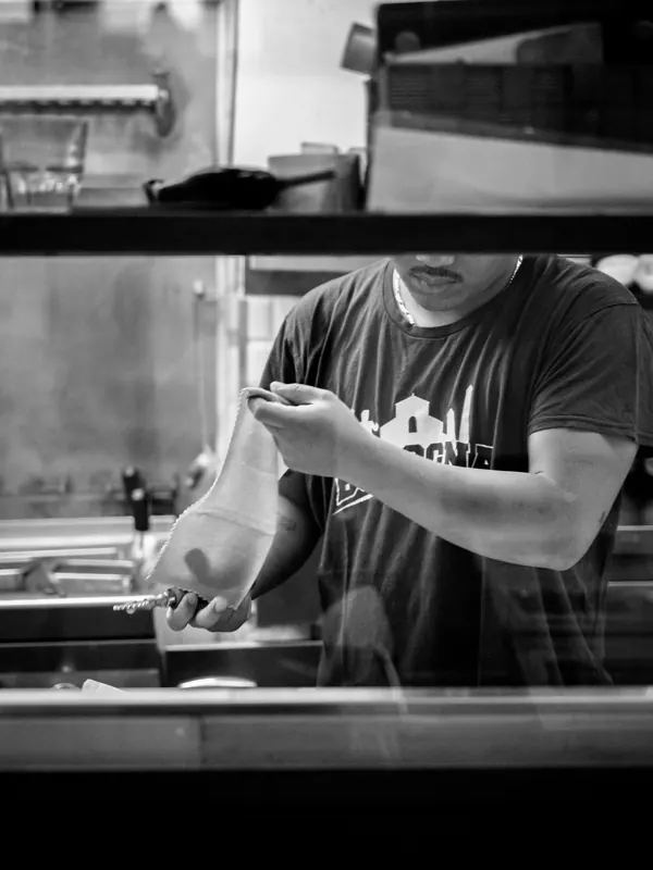 Le Moline chef handing a dish to the pass, kitchen always running