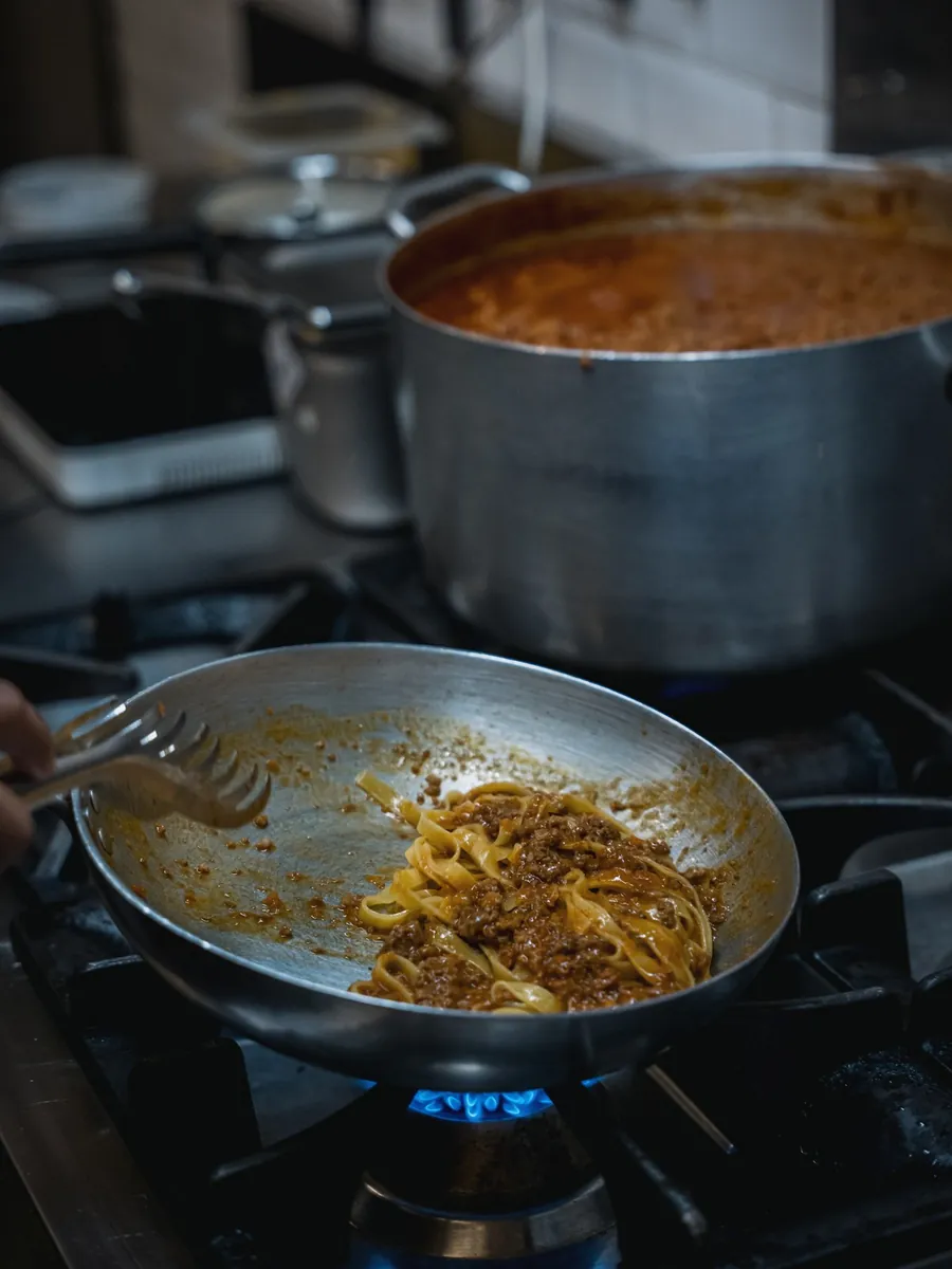 Tagliatelle tossed in the pan with Bolognese ragù in Le Moline kitchen